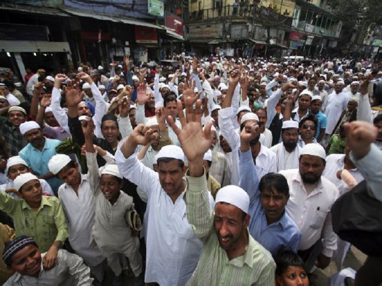 Muslims shout slogans during a protest against the visit of author Salman Rushdie, after offering their Friday prayers, outside Jama Masjid in the old quarters of Delhi March 16, 2012. Rushdie is scheduled to speak at a conference on Friday, under two months after death threats forced the Booker Prize-winning author to pull out of Asia's biggest literary festival, the event organiser said earlier this week. REUTERS/Parivartan Sharma (INDIA - Tags: RELIGION CIVIL UNREST POLITICS)